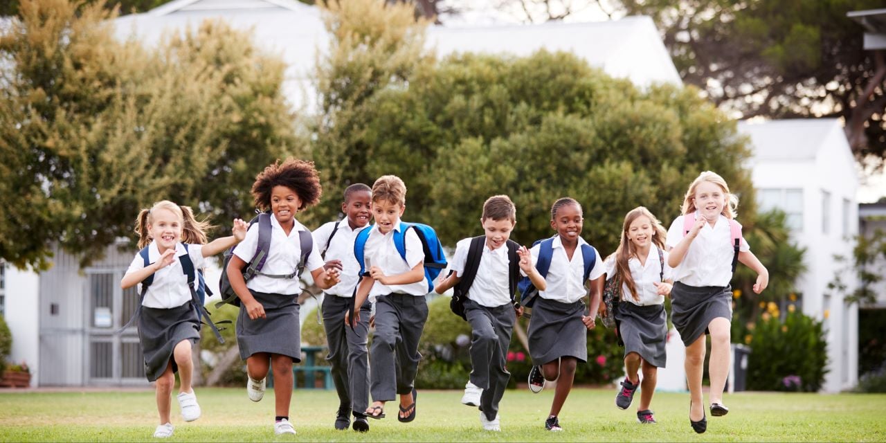 Charter school students running happily outside
