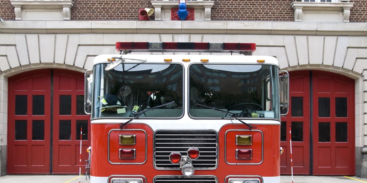 Firetruck in front of a fire station.