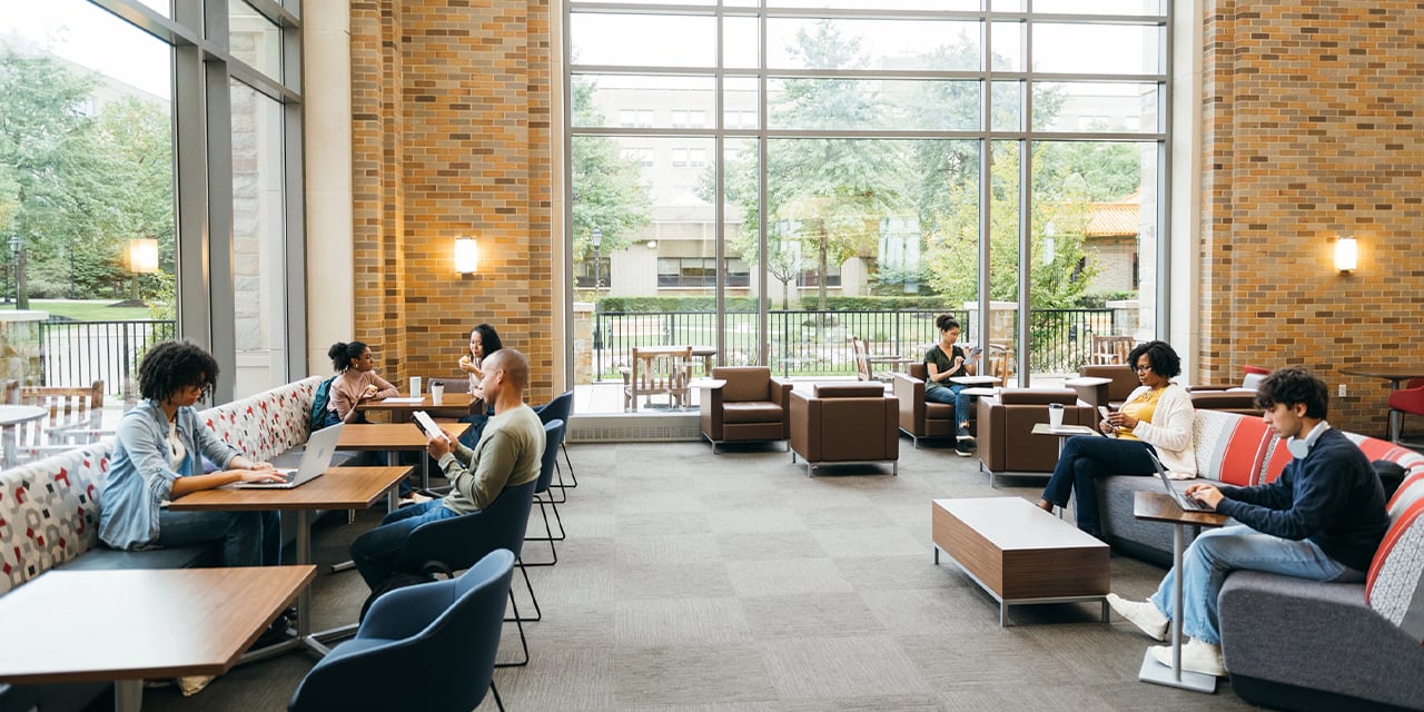 College students sitting in an interior study area on campus.