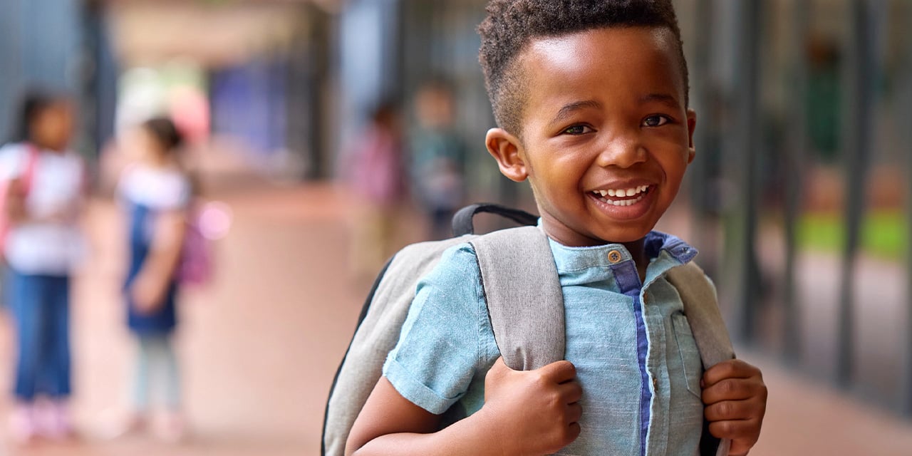 Elementary school aged child wearing a backpack.