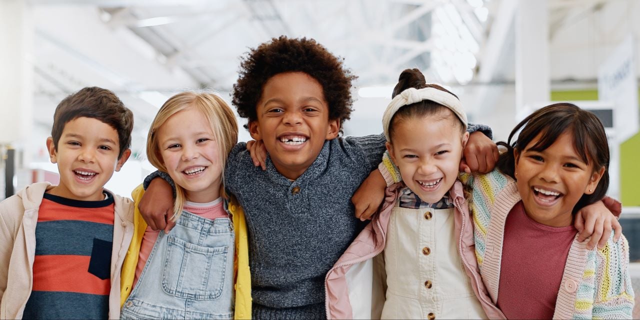 Children smiling and hugging in friendly moment
