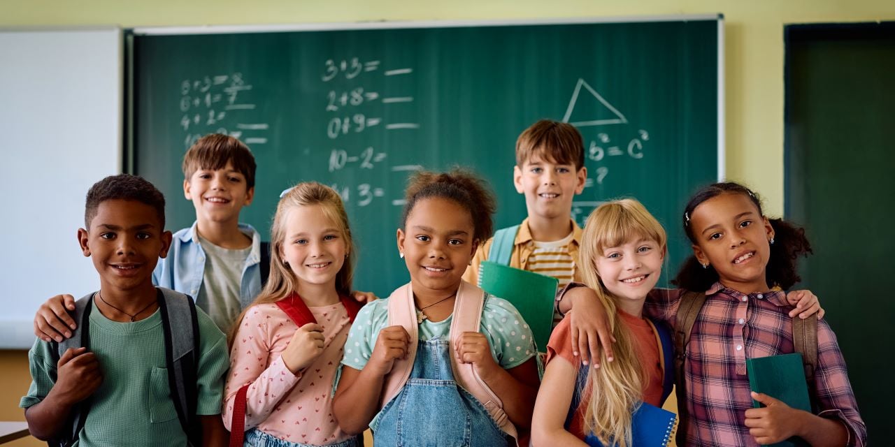 Smiling school children standing together