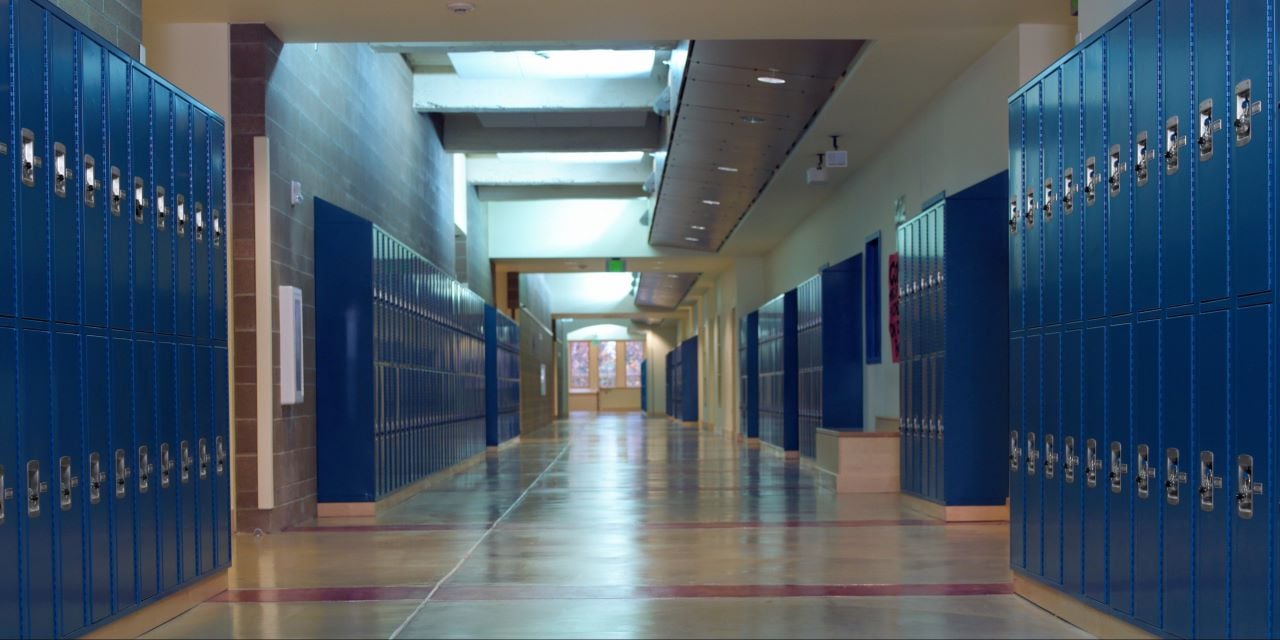 Blue lockers in a school hallway.