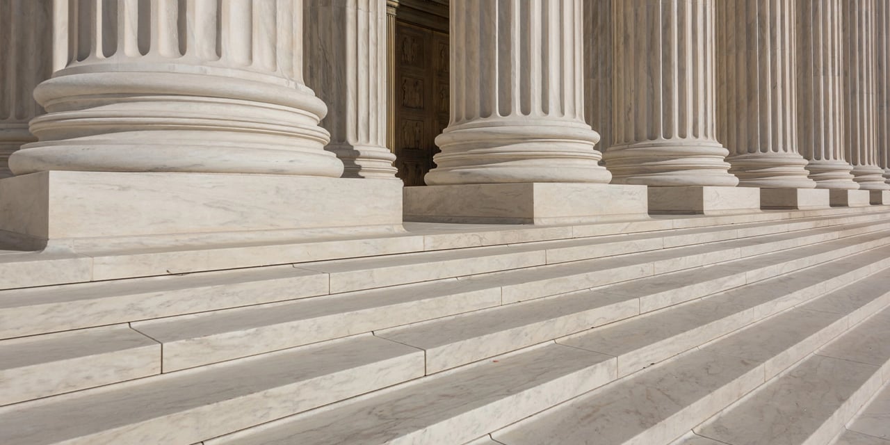 Photo of the base of large stone pillars.