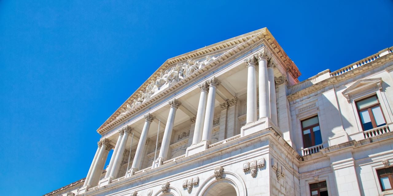 Municipal building with city skyline in background