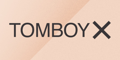 TOMBOYX text on peach background