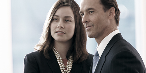 Man and woman dressed in professional attire.