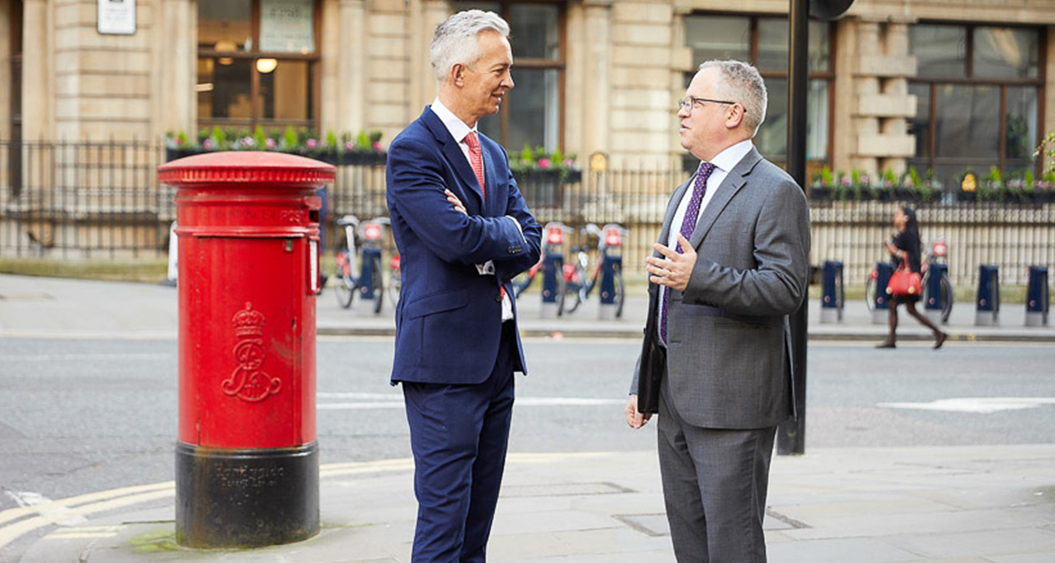 Two men talking on the streets of London.